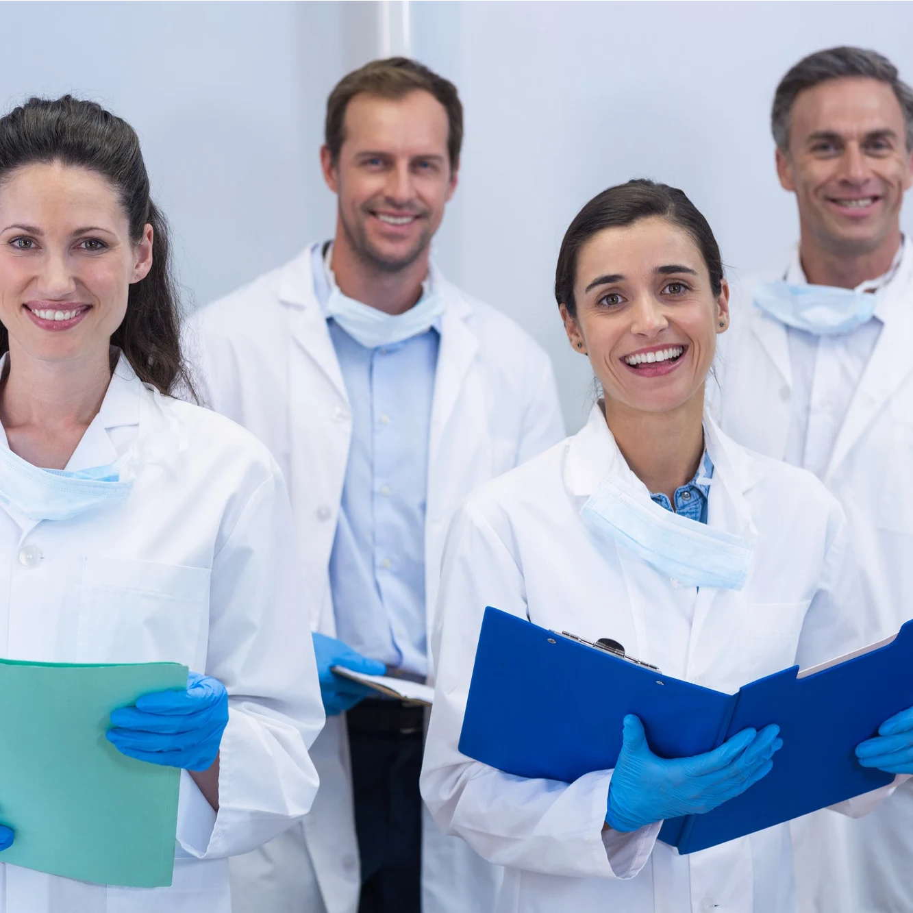 smiling dentists standing in dental clinic